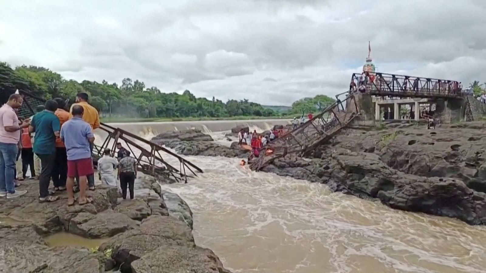 Bridge collapse kills at least two people in India - with several others swept away in river | World News